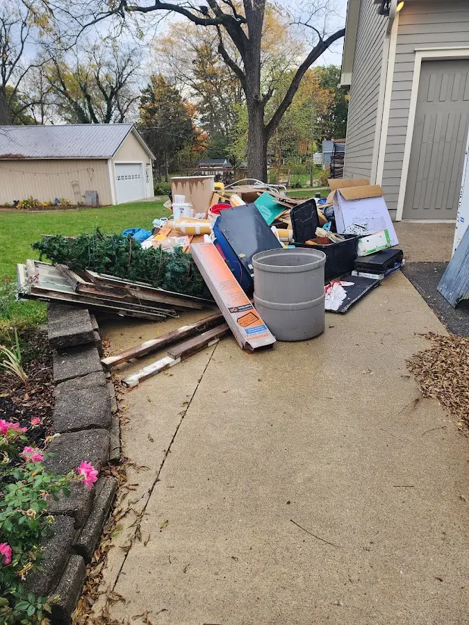 Dumpster being loaded with debris for Roofing Dumpster Rental in Wrightstown
